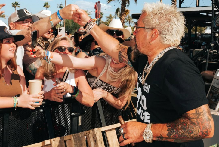 Guy Fieri smiling with fan support