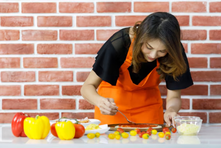 Female chef cooking with ingredients carefully