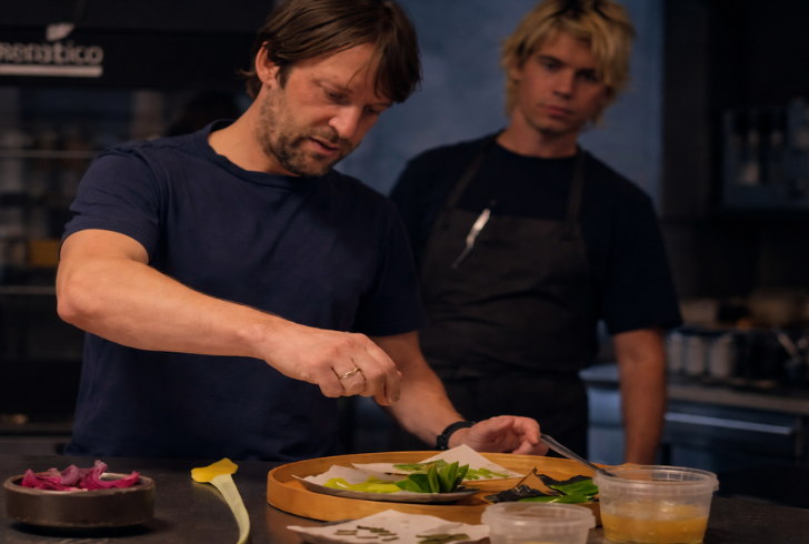 Chef René Redzepi cooking in kitchen